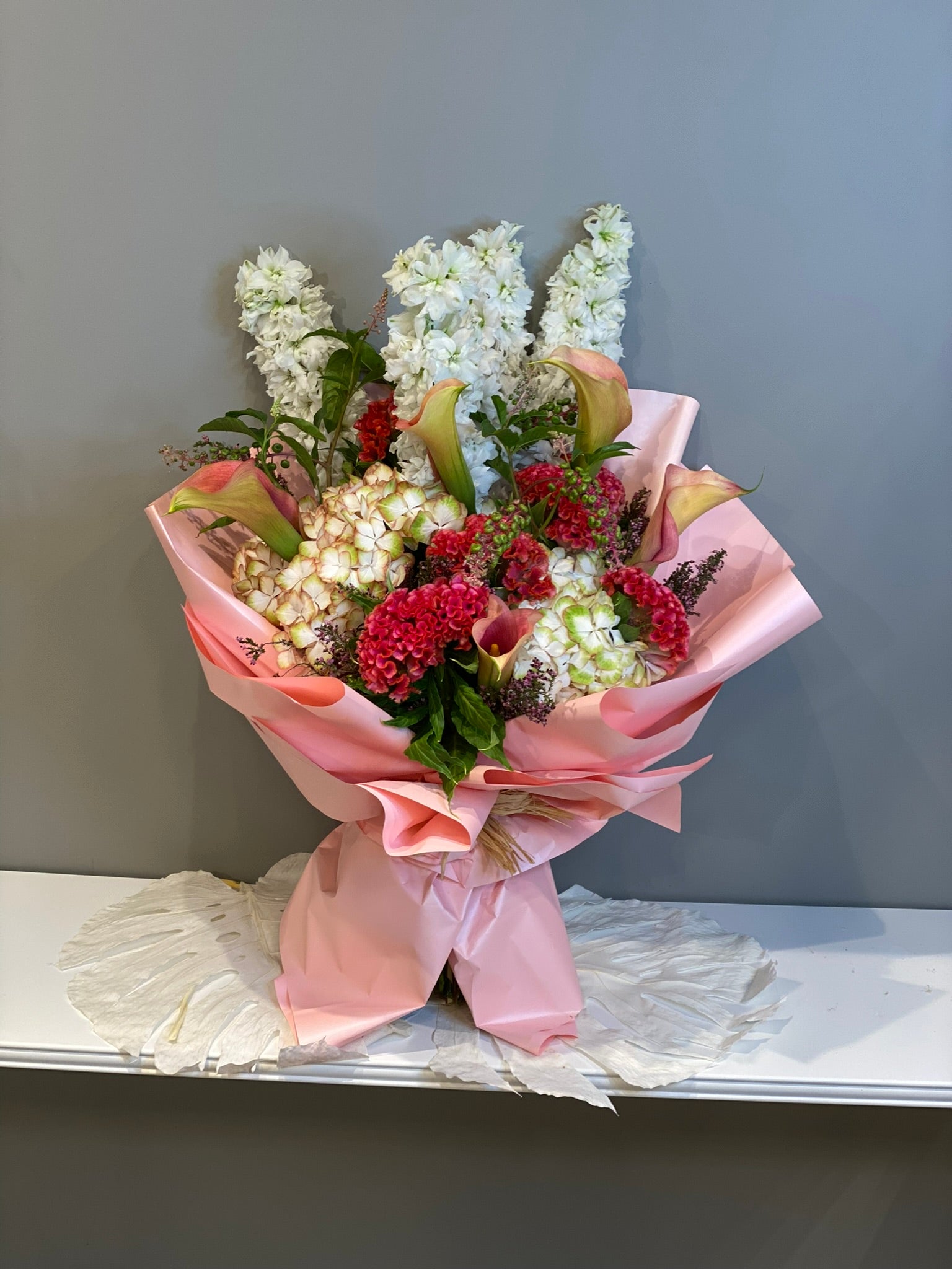 Luxury Mixed Flower Bouquet - White Stock, Red Carnations & Calla Lilies in Pink Wrapping Dubai